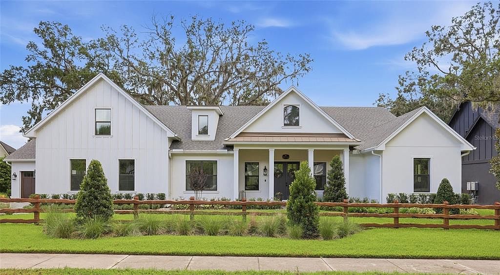 Front of the modern farmhouse under the oak trees